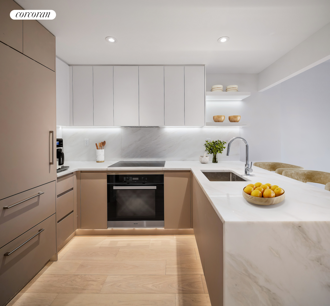 355 West 39th Street, Unit 3B Manhattan, NY 10018 - Photo 3 of 9 a kitchen with a sink and stove top oven