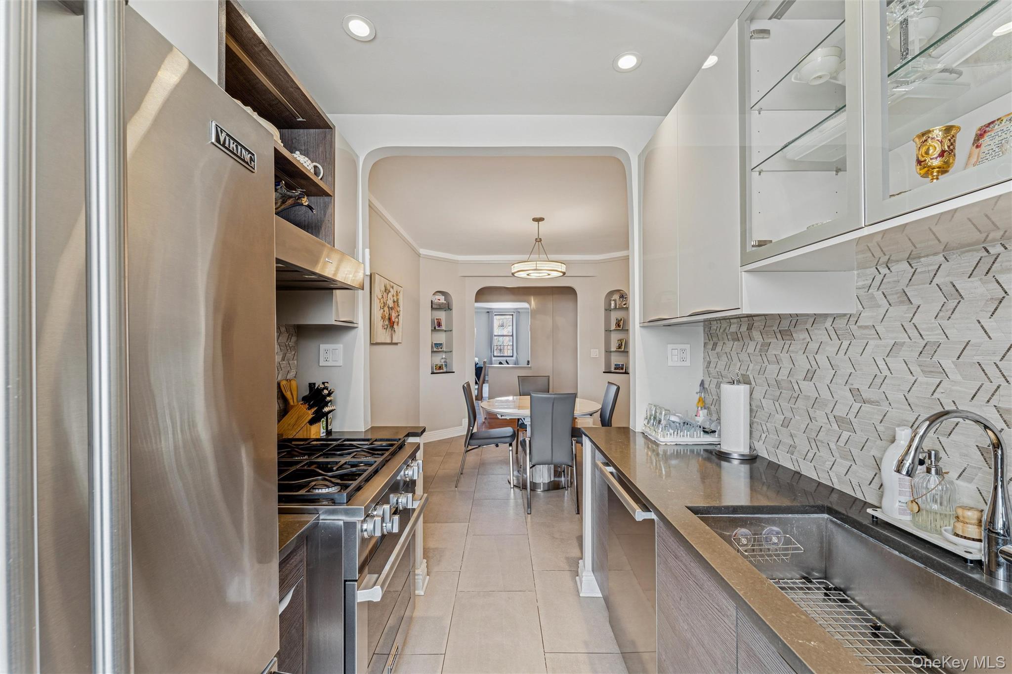 84-51 Beverly Road, Unit 6R Queens, NY 11415 - Photo 11 of 19 a kitchen with stainless steel appliances granite countertop a sink a stove and a refrigerator