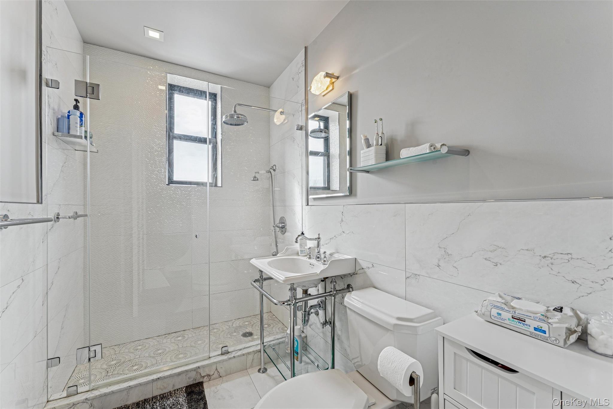 84-51 Beverly Road, Unit 6R Queens, NY 11415 - Photo 14 of 19 a bathroom with a sink mirror and toilet