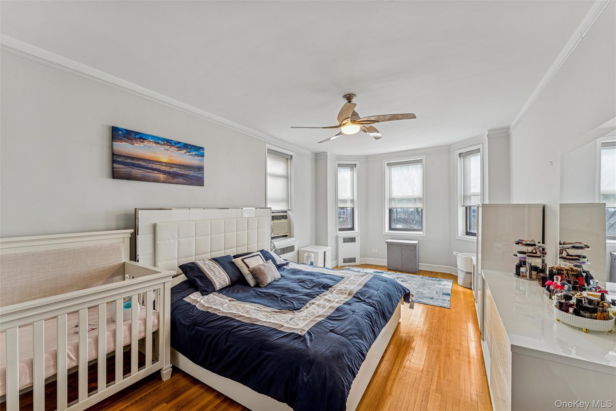 84-51 Beverly Road, Unit 6R Queens, NY 11415 - Photo 15 of 19 a spacious bedroom with a bed and a chandelier