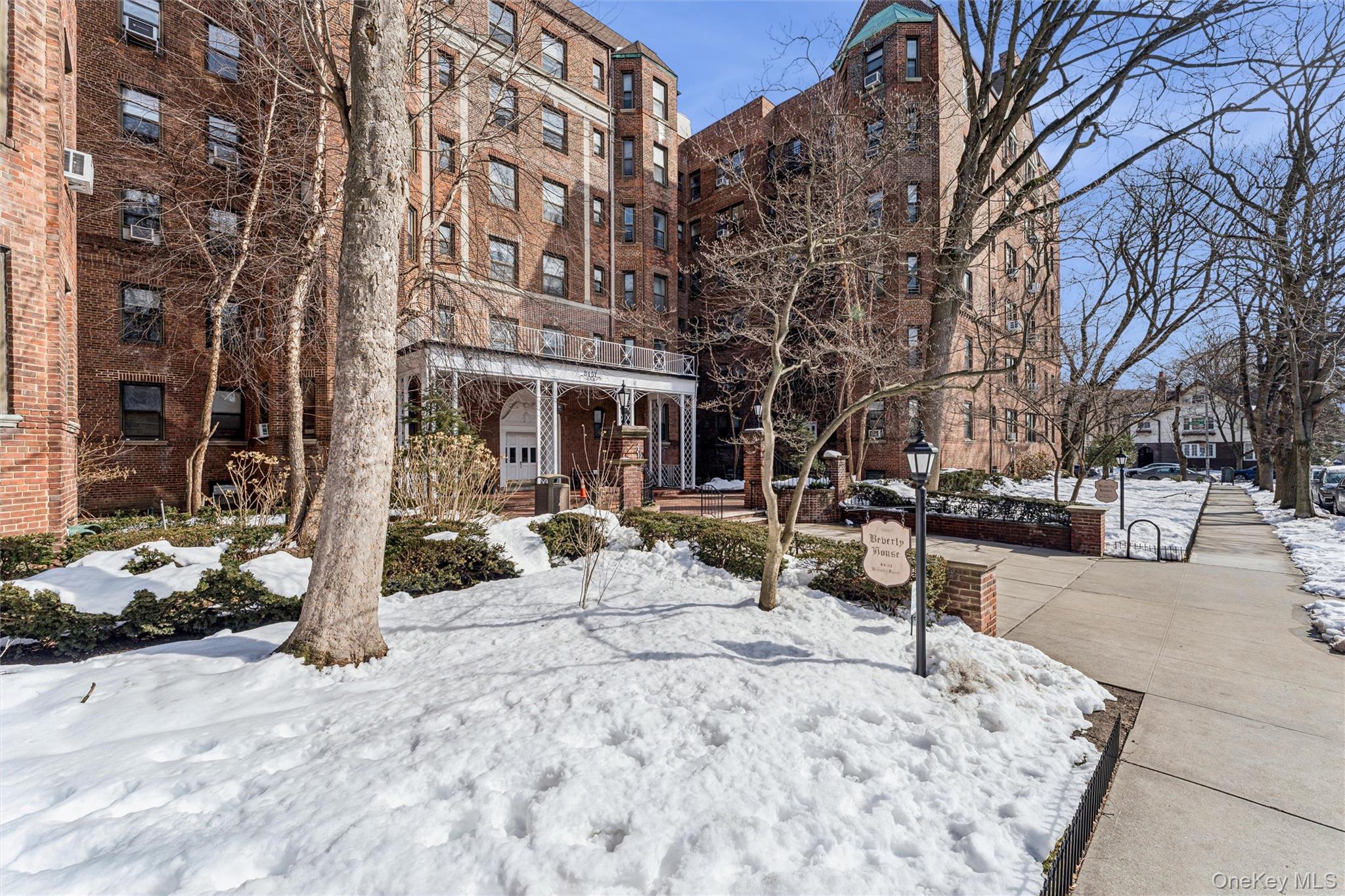 84-51 Beverly Road, Unit 6R Queens, NY 11415 - Photo 18 of 19 a row of palm trees sitting in front of a building