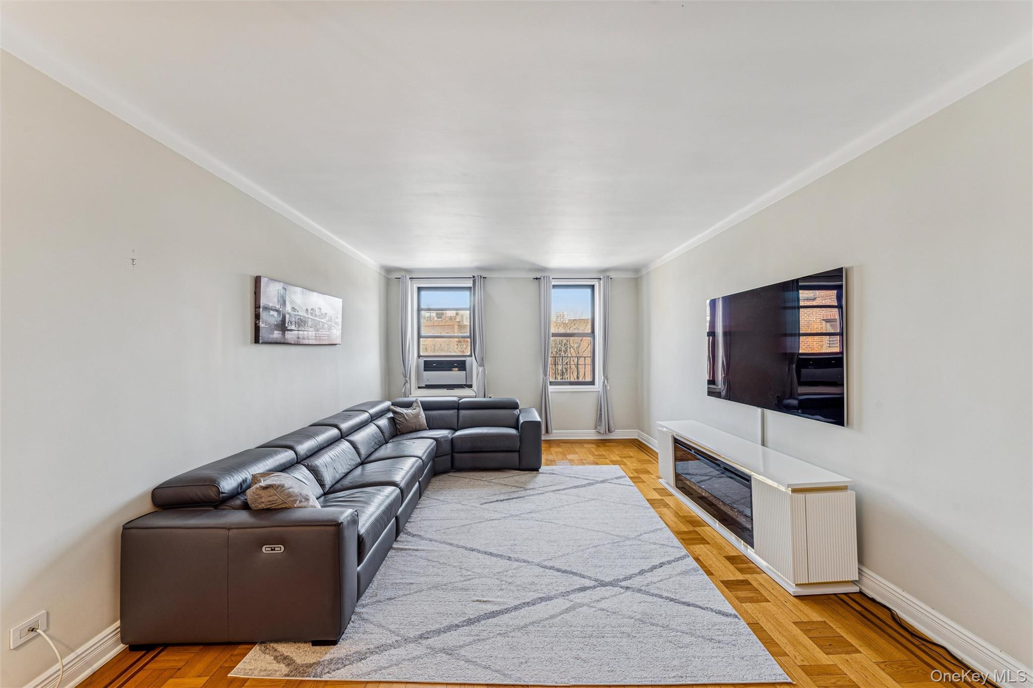 84-51 Beverly Road, Unit 6R Queens, NY 11415 - Photo 3 of 19 a living room with furniture and a flat screen tv