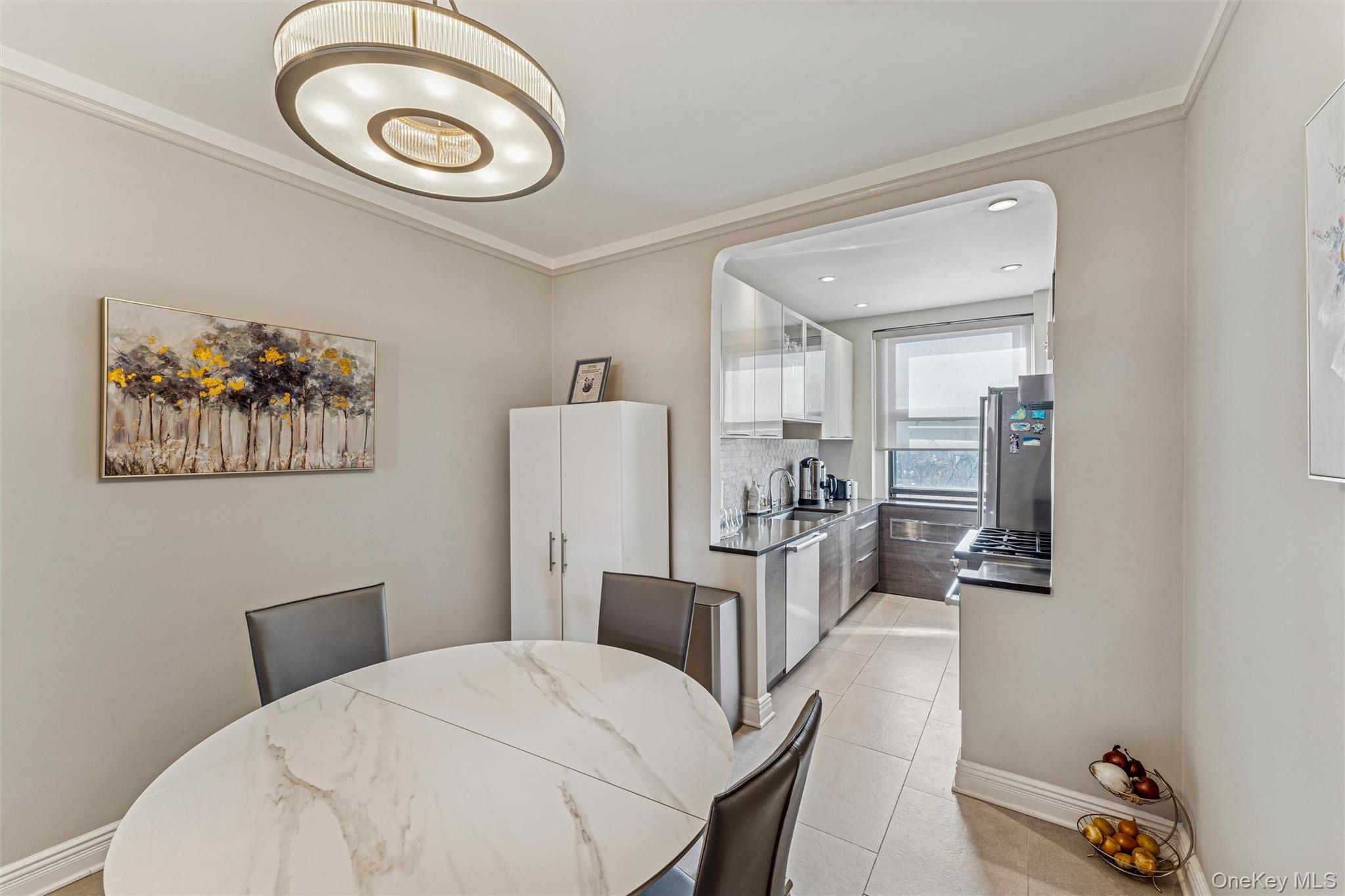 84-51 Beverly Road, Unit 6R Queens, NY 11415 - Photo 8 of 19 a bedroom with a bed and a chandelier