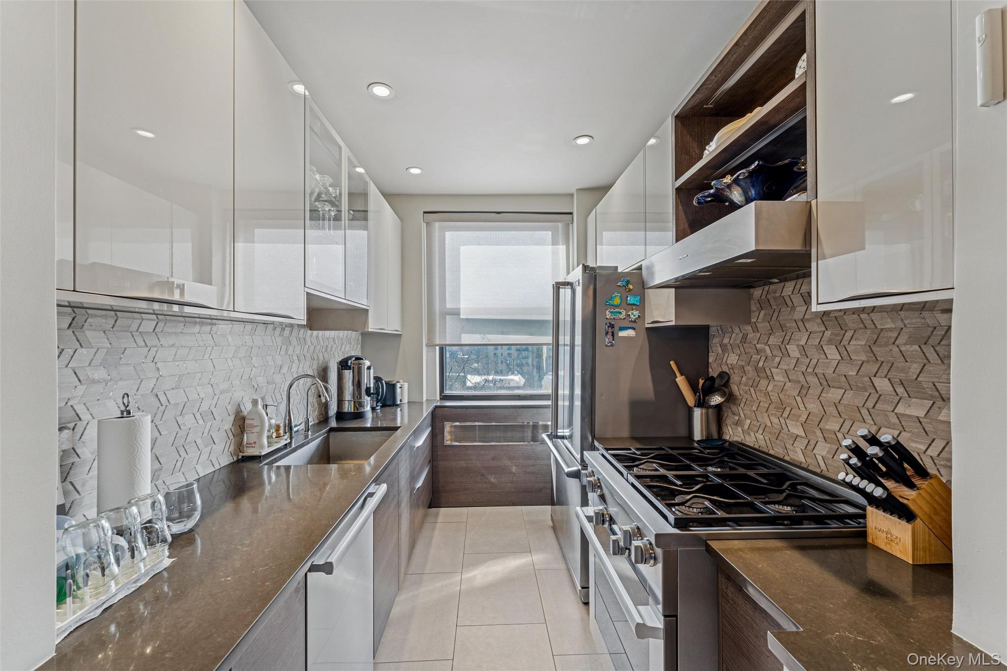 84-51 Beverly Road, Unit 6R Queens, NY 11415 - Photo 9 of 19 a kitchen with granite countertop a sink stainless steel appliances and cabinets