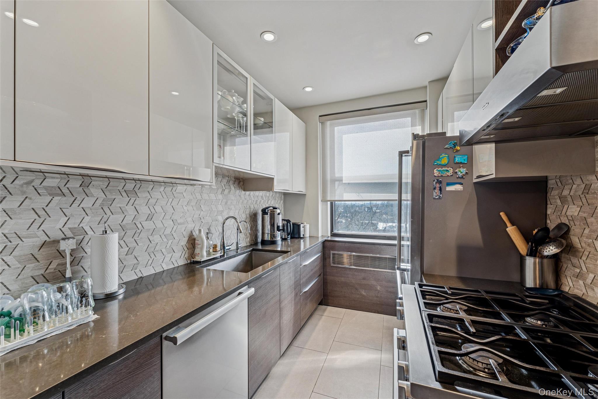 84-51 Beverly Road, Unit 6R Queens, NY 11415 - Photo 10 of 19 a kitchen with granite countertop a sink stove and cabinets