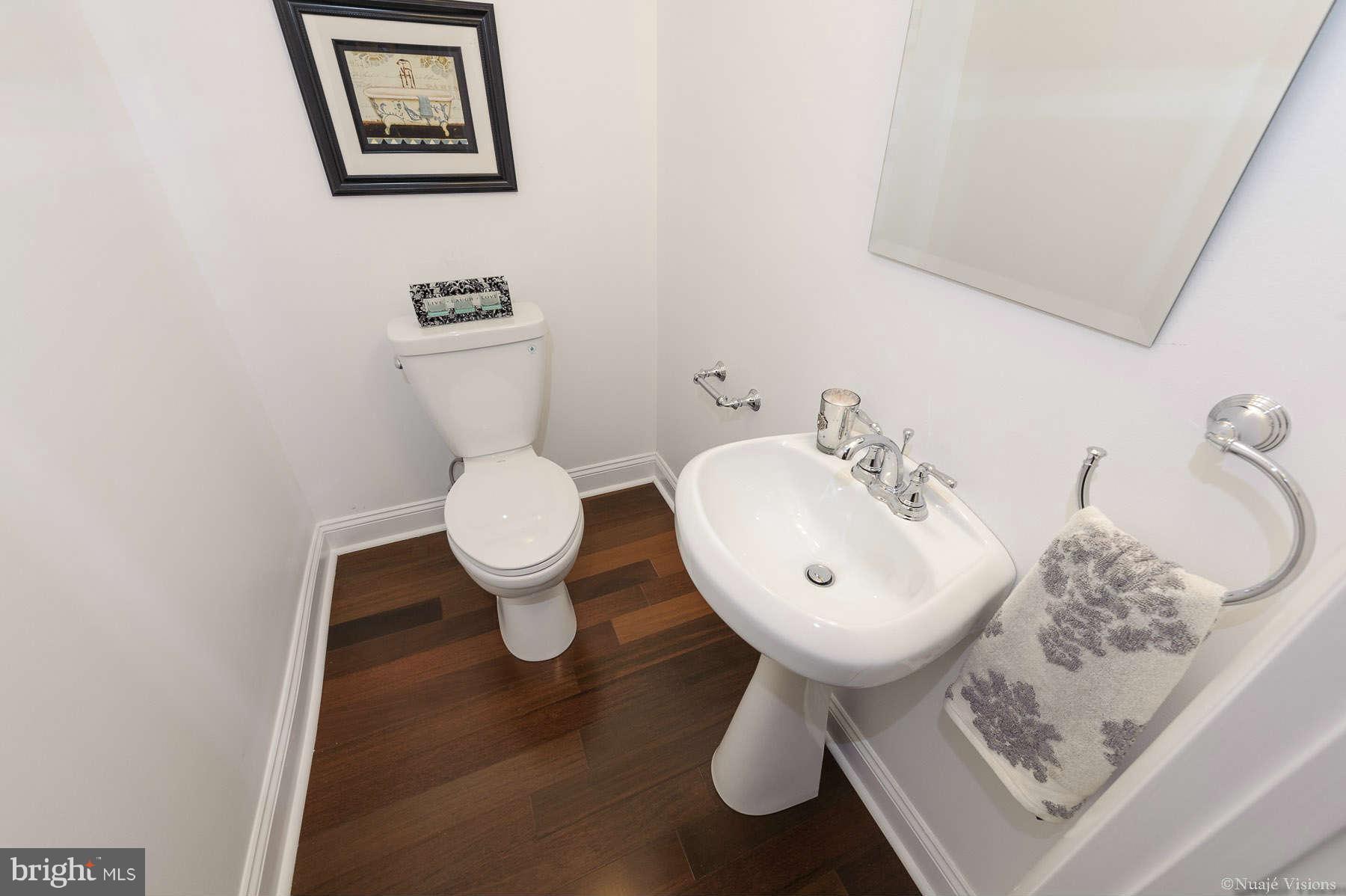 835 Milford Mill Road Baltimore, MD 21208 - Photo 17 of 30 a bathroom with a toilet sink and mirror