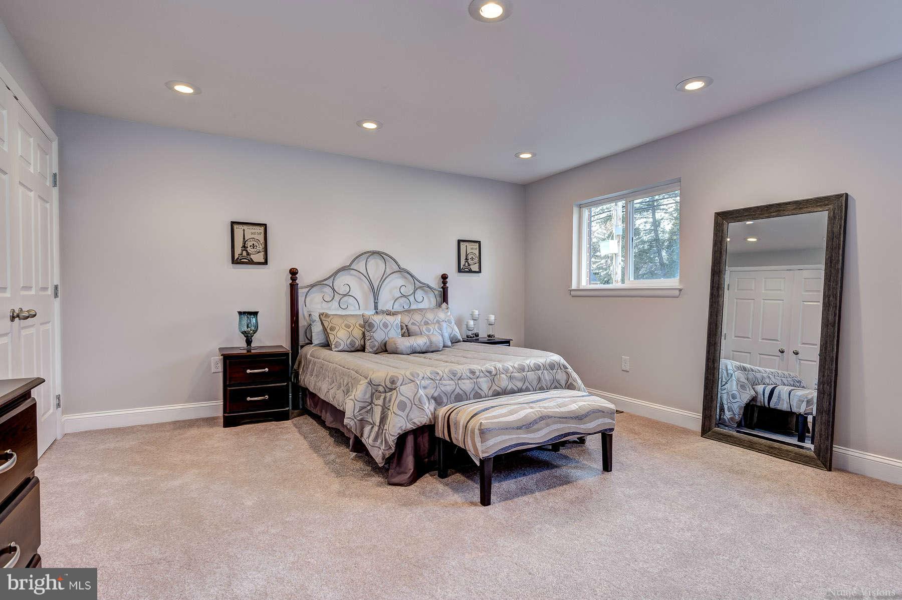 835 Milford Mill Road Baltimore, MD 21208 - Photo 21 of 30 a spacious bedroom with a bed and a window