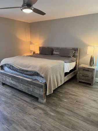 a bedroom with a bed and a large window