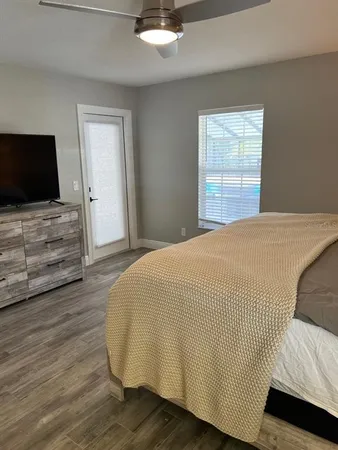 a bedroom with a bed and a flat screen tv