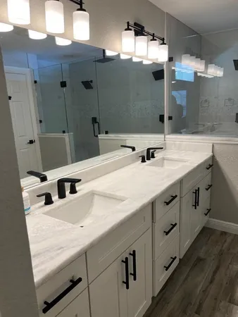 a bathroom with a sink mirror and toilet
