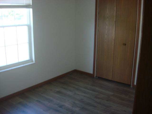 601 Catlin Street Ottawa, IL 61350 - Photo 13 of 29 an empty room with wooden floor and windows
