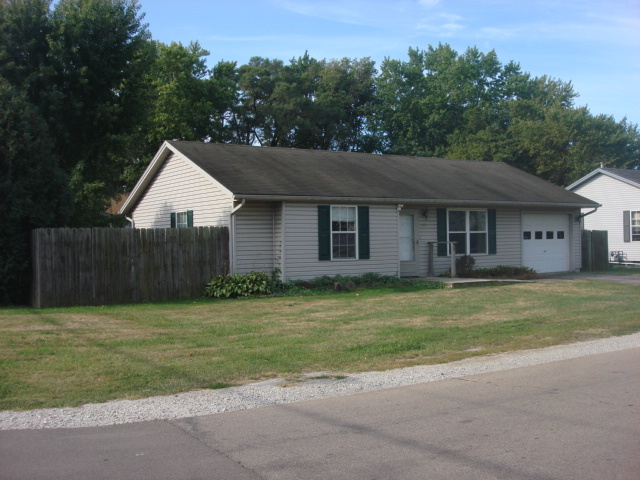 601 Catlin Street Ottawa, IL 61350 - Photo 2 of 29 a front view of a house with a garden and trees