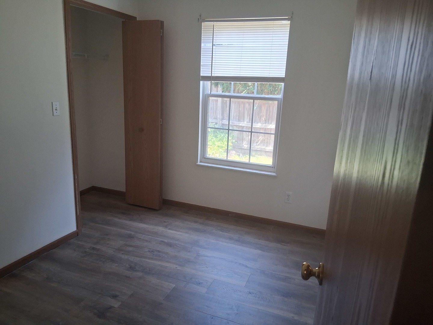 601 Catlin Street Ottawa, IL 61350 - Photo 8 of 29 an empty room with wooden floor and windows