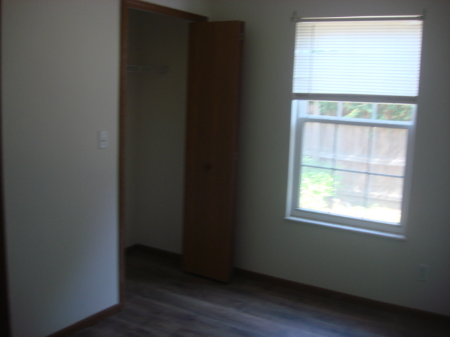 601 Catlin Street Ottawa, IL 61350 - Photo 10 of 29 an empty room with wooden floor and a window