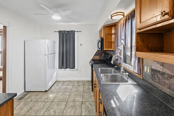 a kitchen with a sink and a refrigerator