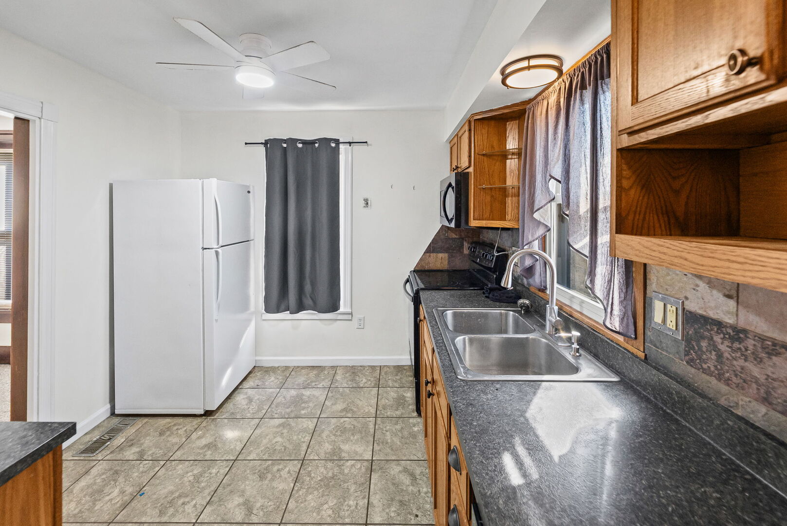 527 East 4th Street Centralia, IL 62801 - Photo 20 of 39 a kitchen with a sink and a refrigerator