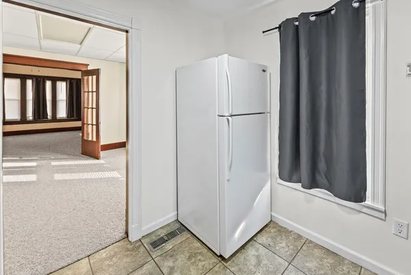 a view of a refrigerator in kitchen and furniture