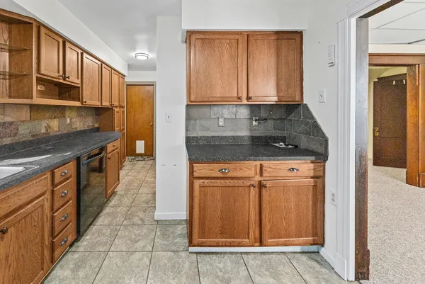 a kitchen with stainless steel appliances granite countertop a refrigerator and a sink