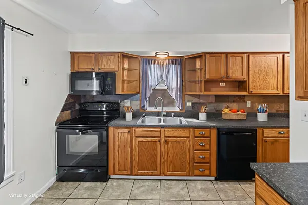 a kitchen with stainless steel appliances granite countertop a stove sink and cabinets