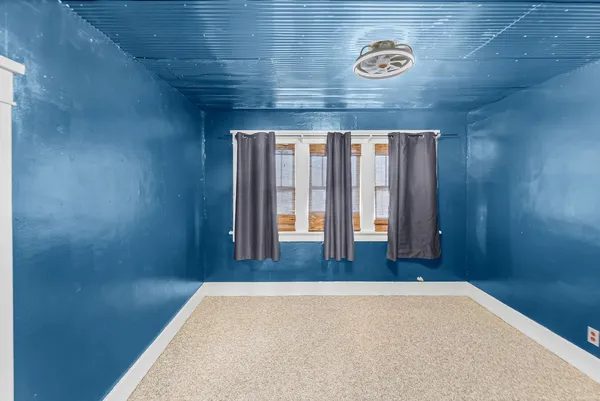 a view of a hallway with wooden walls and floor to ceiling window