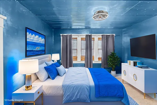 a bedroom with a bed and a flat screen tv