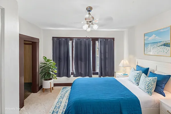 a bedroom with a balcony a bed and a chandelier