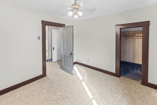 a view of a room with an empty space and a hallway