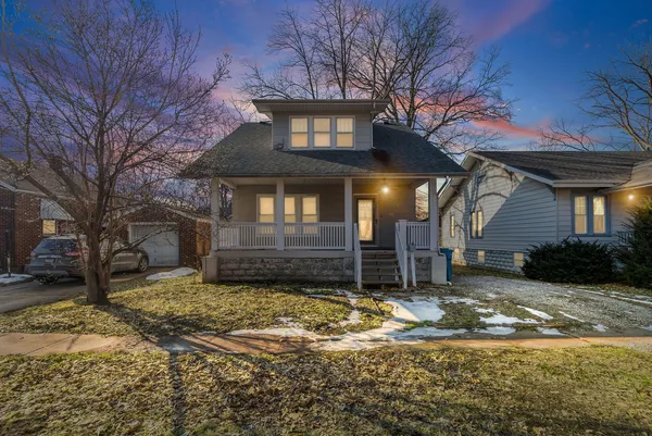 a view of a house with a yard covered in snow