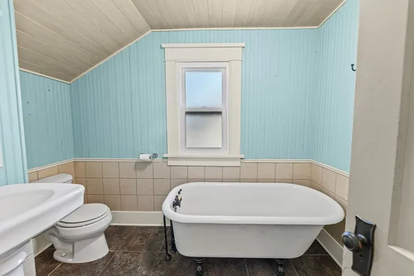 a white bath tub sitting next to a white toilet