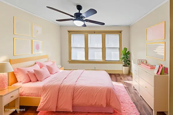 a bedroom with a large bed and a large window