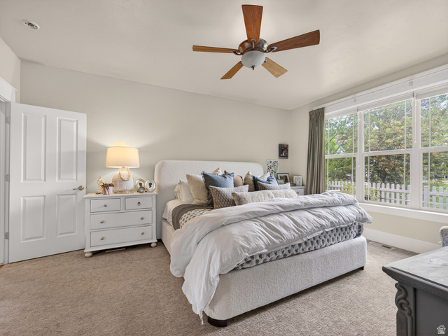 557 Craftsman Way Midway, UT 84049 - Photo 24 of 59 Carpeted interior space featuring a multi-pane window with white trim, a ceiling fan with wood-finish blades, and a white interior door
