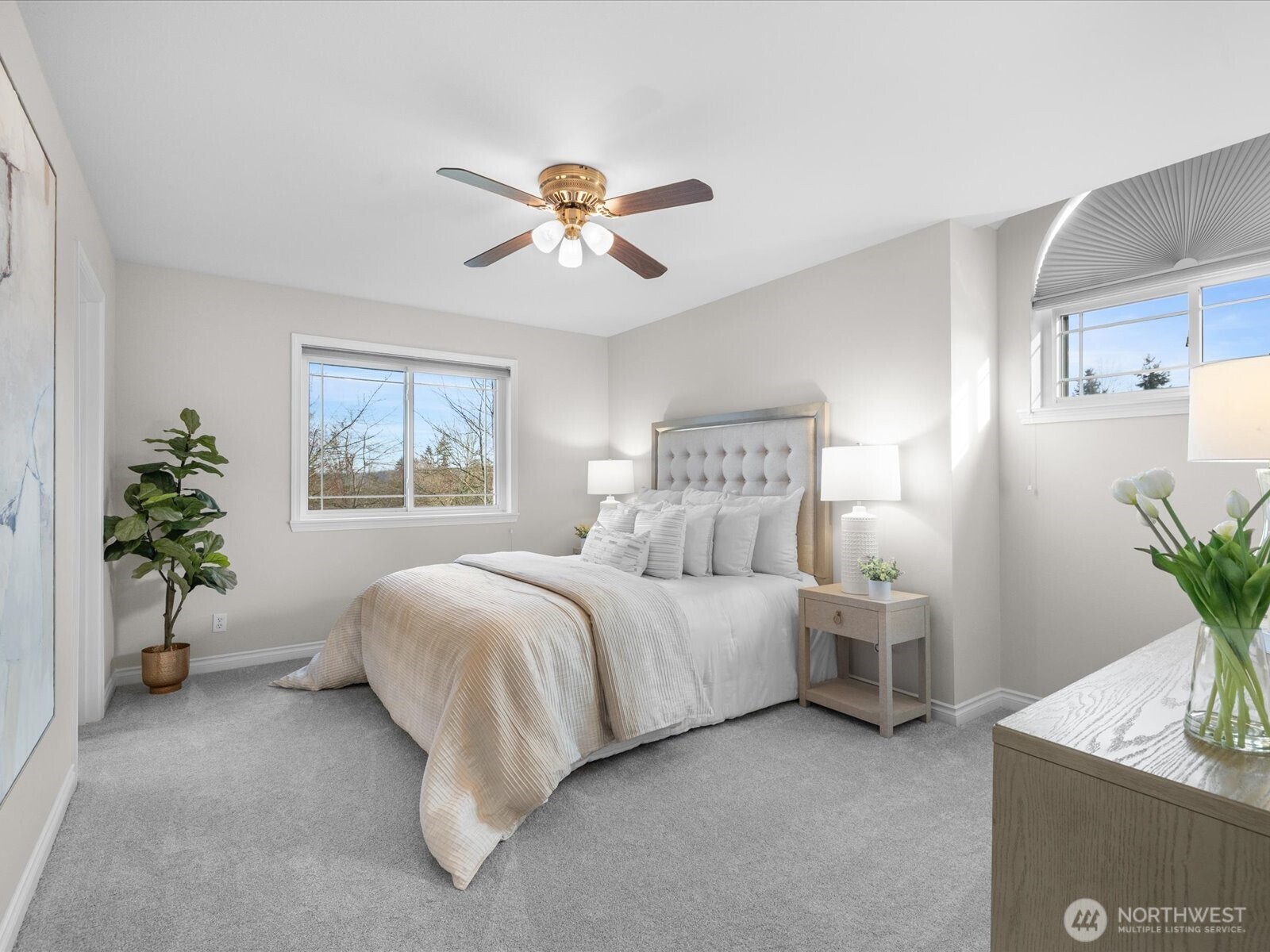 12103 Northeast 168th Place Bothell, WA 98011 - Photo 17 of 36 a spacious bedroom that has a bed and a potted plant