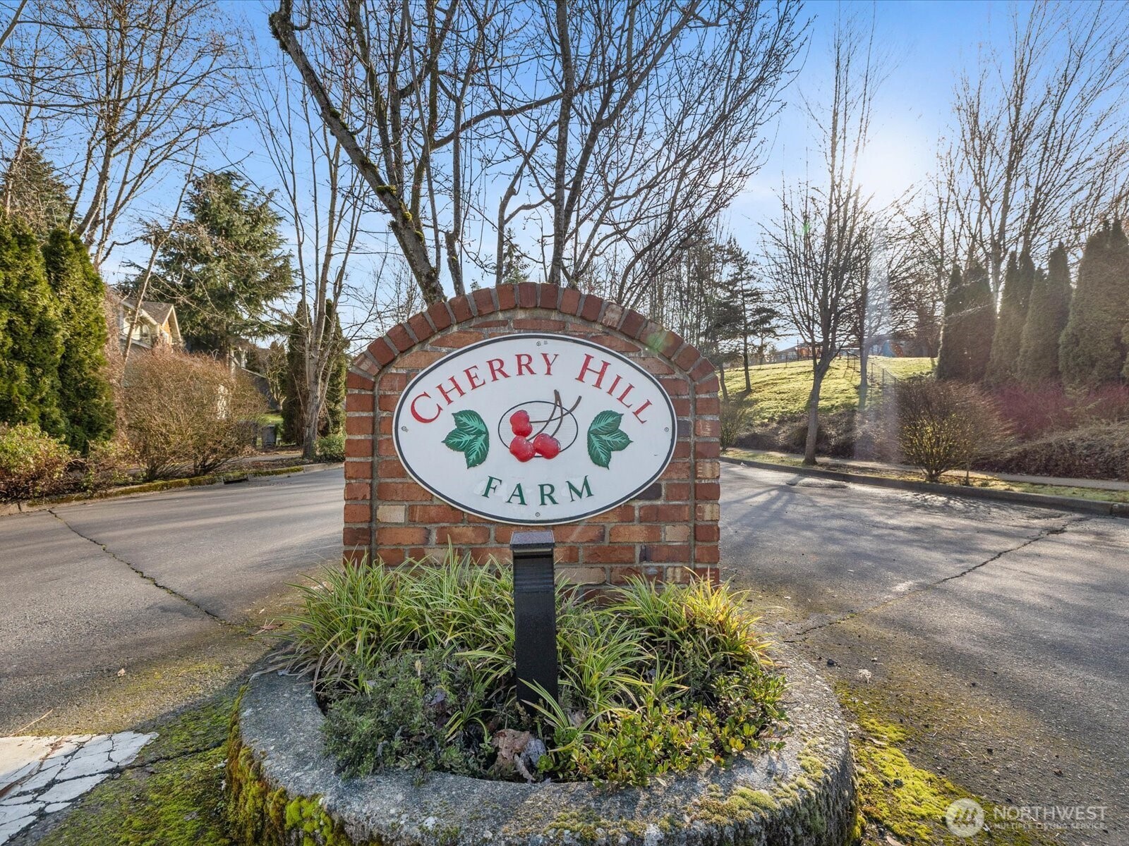 12103 Northeast 168th Place Bothell, WA 98011 - Photo 2 of 36 a sign that is sitting on a brick wall