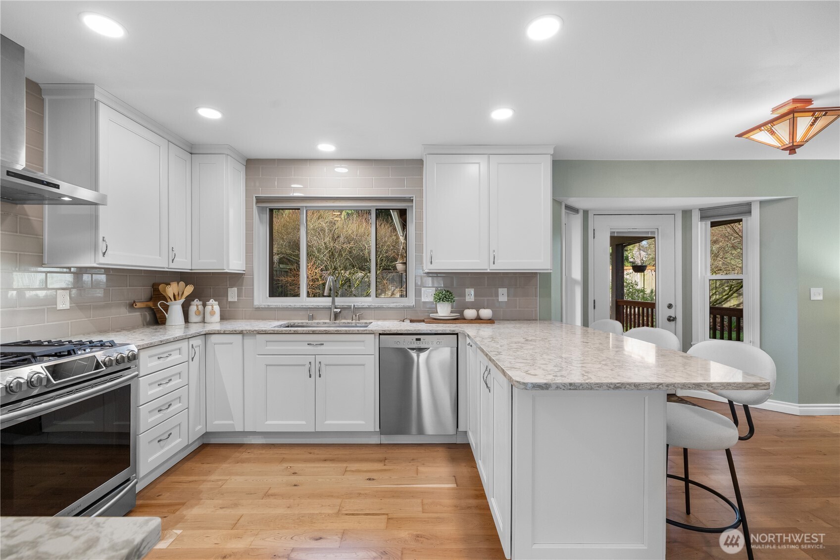 12103 Northeast 168th Place Bothell, WA 98011 - Photo 8 of 36 a large kitchen with kitchen island a sink stove and white cabinets