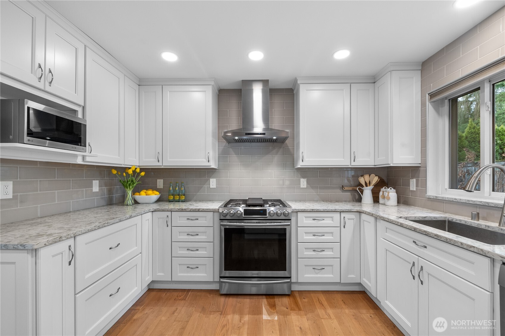 12103 Northeast 168th Place Bothell, WA 98011 - Photo 9 of 36 a kitchen with granite countertop white cabinets and stainless steel appliances