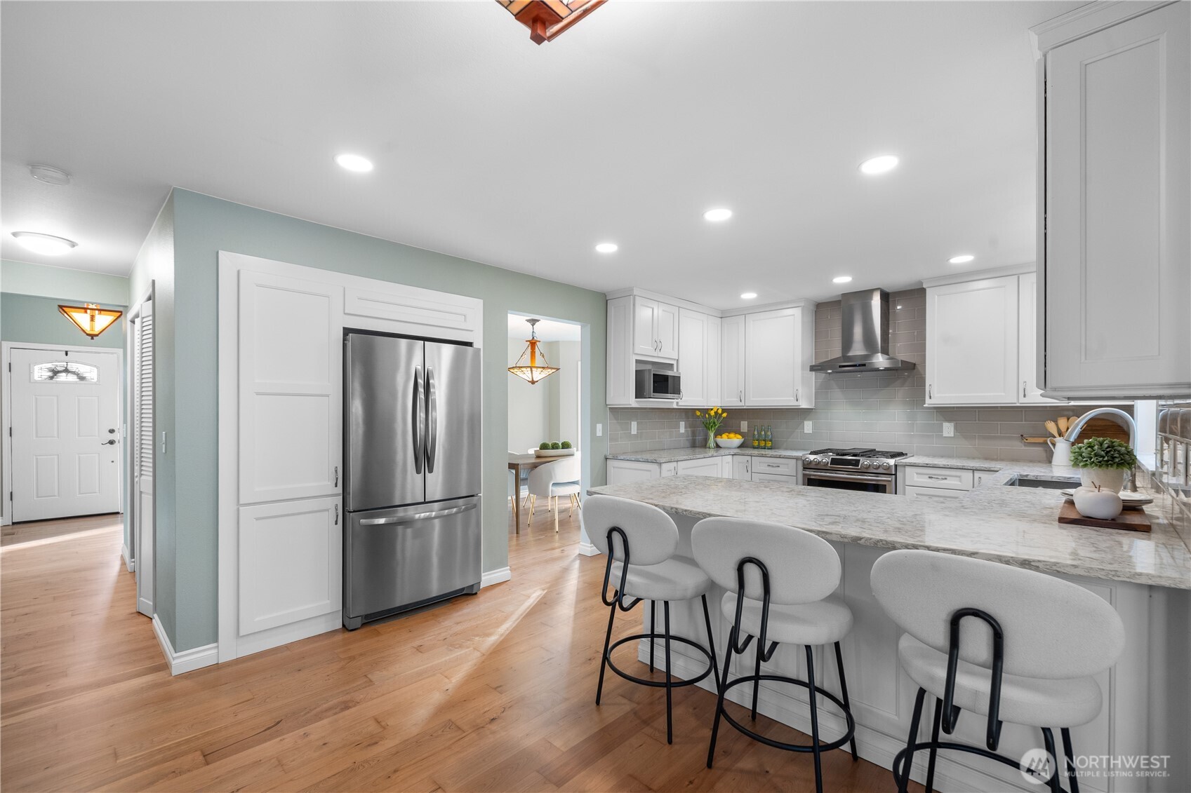 12103 Northeast 168th Place Bothell, WA 98011 - Photo 10 of 36 a kitchen with refrigerator a sink and chairs