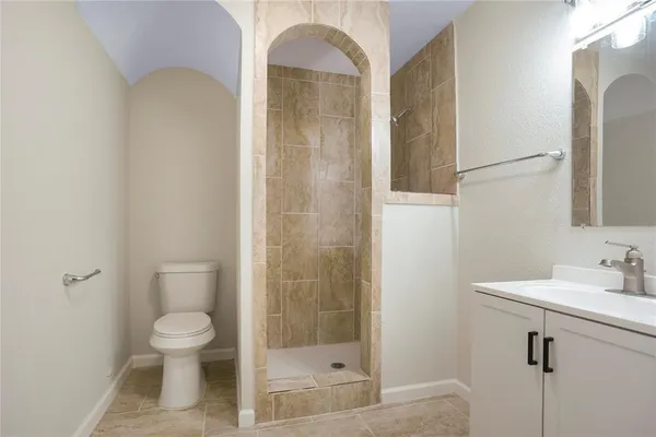 a bathroom with a toilet a sink and shower