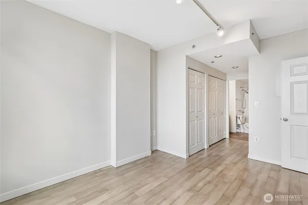 a view of an empty room with wooden floor