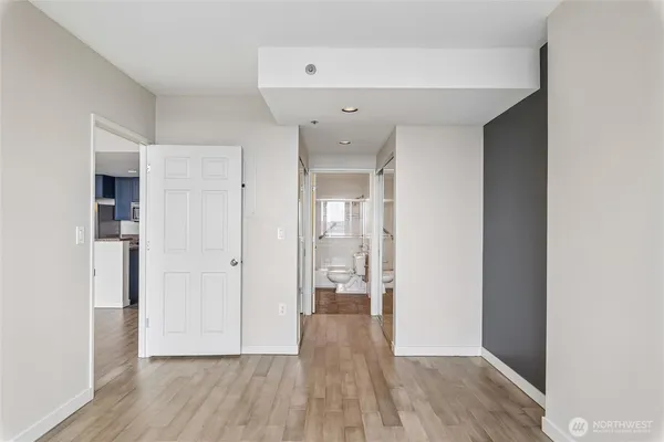 a view of hallway with wooden floor