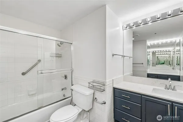 a bathroom with a sink toilet vanity and shower