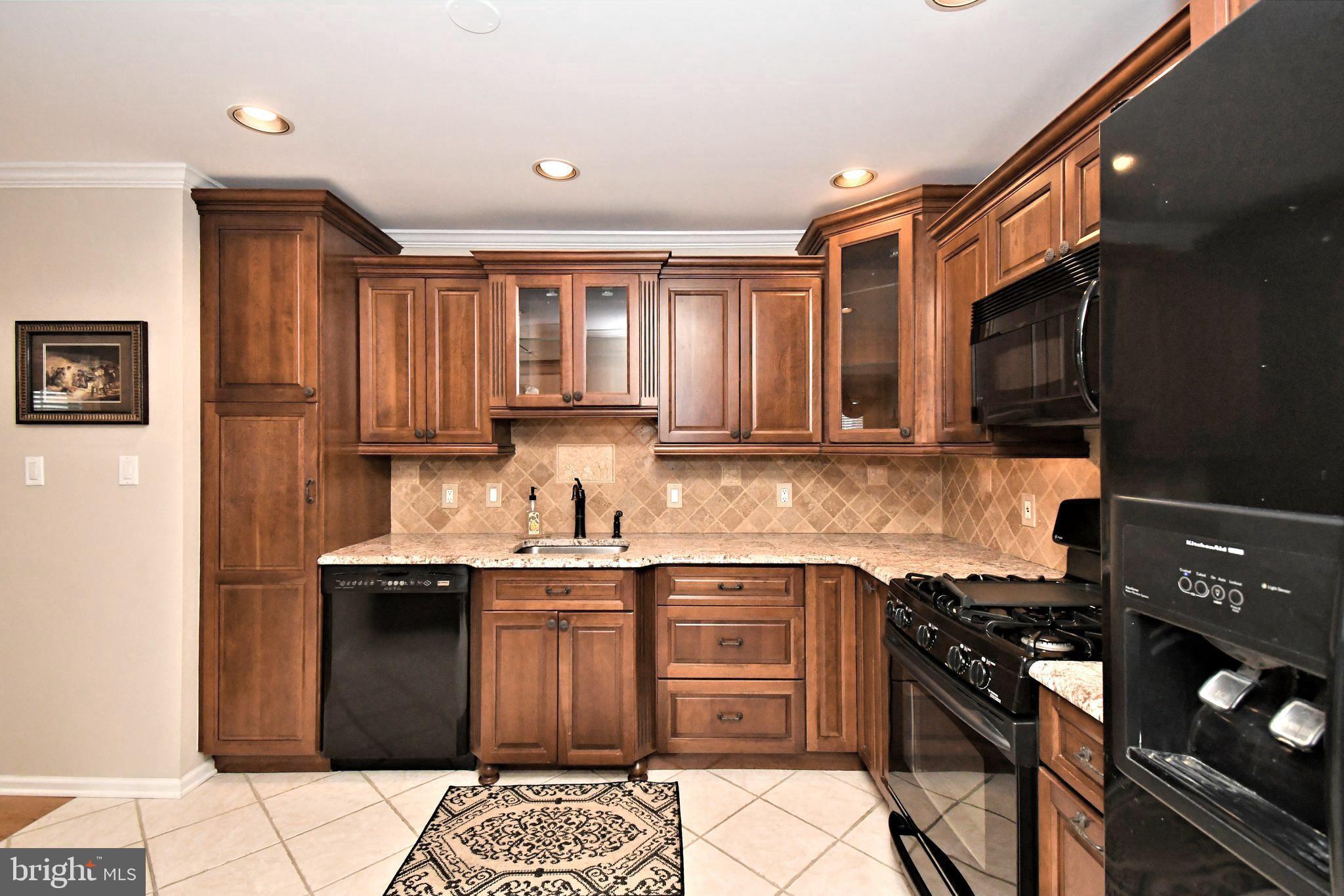 1651 Covington Road Yardley, PA 19067 - Photo 11 of 59 a kitchen with stainless steel appliances granite countertop a sink stove top oven and cabinets