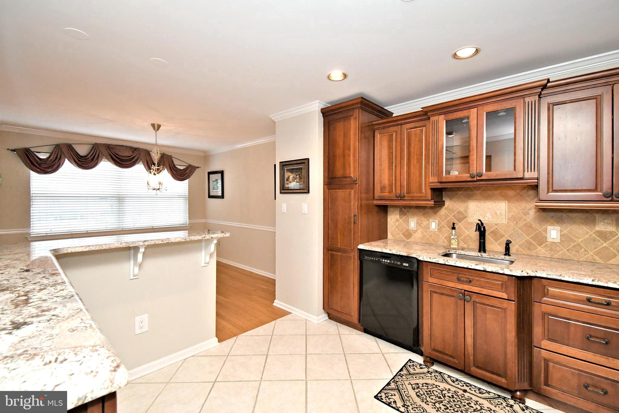 1651 Covington Road Yardley, PA 19067 - Photo 13 of 59 a kitchen with granite countertop a sink stove and cabinets