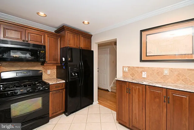 a view of a kitchen with an entryway and wooden floor