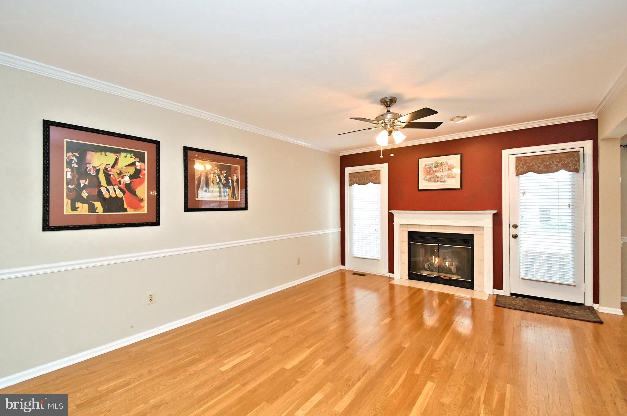 1651 Covington Road Yardley, PA 19067 - Photo 22 of 59 a view of a livingroom with a fireplace a ceiling fan and wooden floor