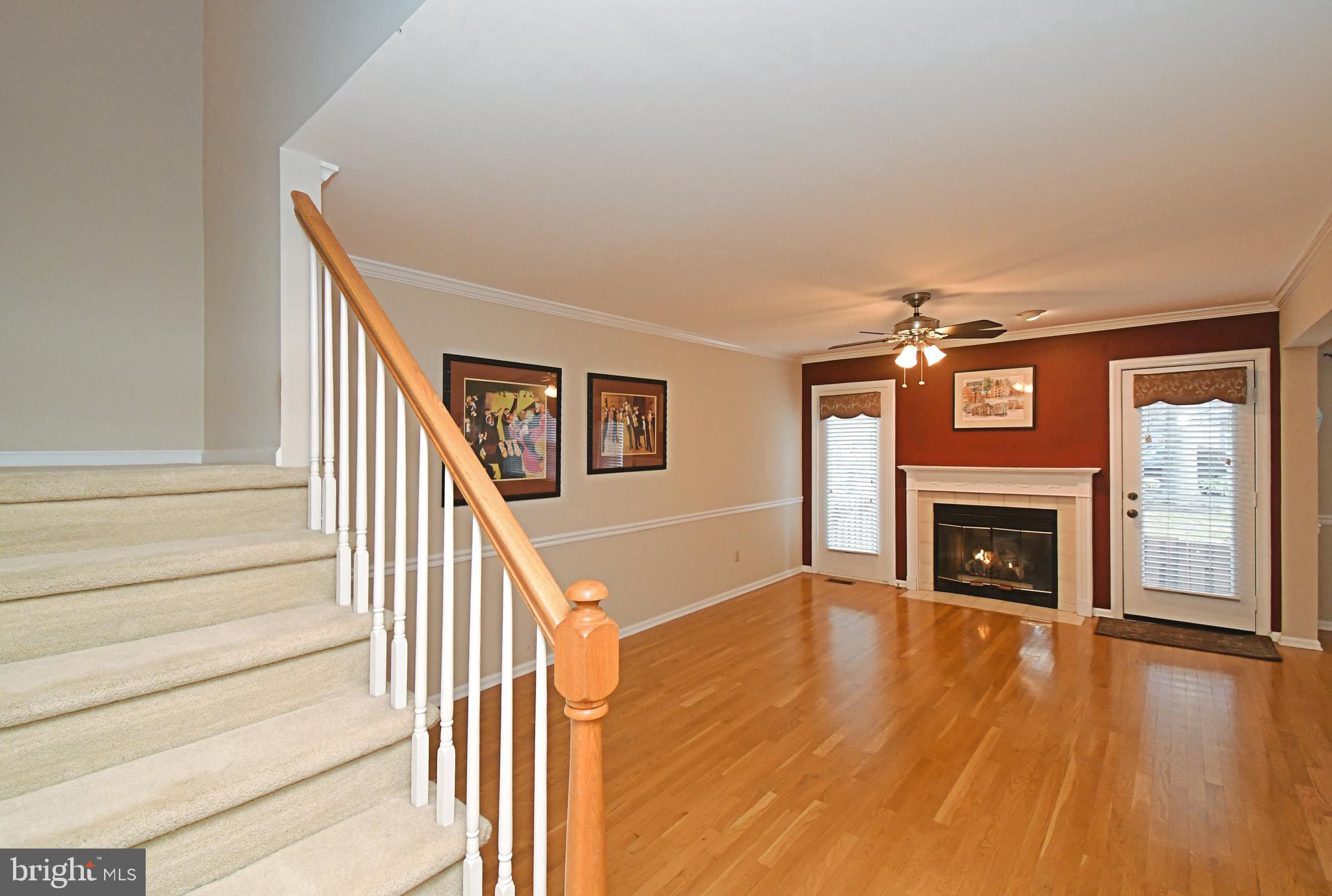 1651 Covington Road Yardley, PA 19067 - Photo 26 of 59 a view of an empty room with wooden floor fireplace and a window