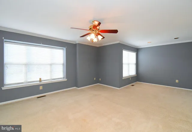 a view of a livingroom with a chandelier fan