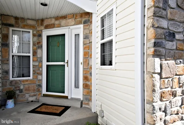 a view of hallway with stairs and wooden floor