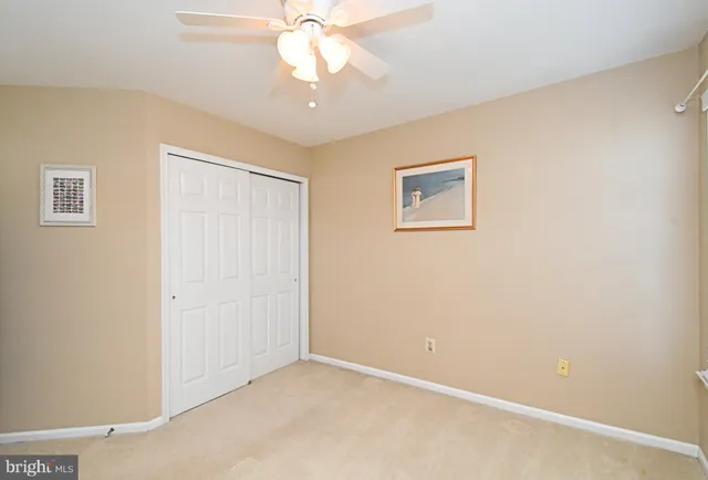 a view of staircase with wooden floor and white walls
