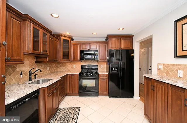 a kitchen with granite countertop a stove and a sink