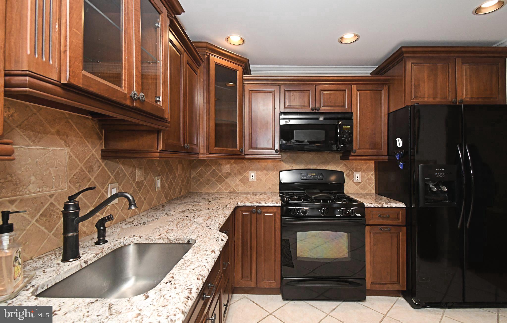 1651 Covington Road Yardley, PA 19067 - Photo 10 of 59 a kitchen with granite countertop a stove and a sink